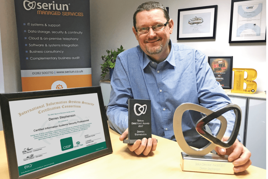 Man posing with awards